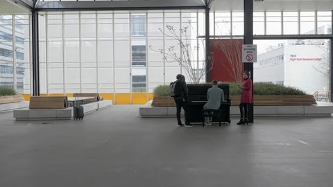 Students take a coffee break and playing piano in front of TU University. Stock Footage 100275026