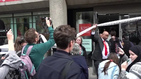 Students take part in an inter-university march for Gaza outside King's College Stock Footage 318539457