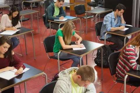 Students taking an exam in classroom 写真素材