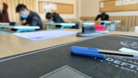 Students taking an exam at school in coronavirus epidemic disease, Stock Footage 150750652