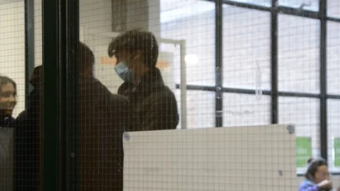 Students talking in library on university campus wearing a face mask Stock Footage 126298458