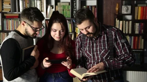 Students talking together in the library and searching for information Video stock 84835970