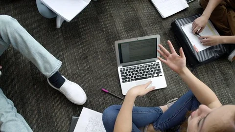 Students talking while studying together on floor Video stock 83398961