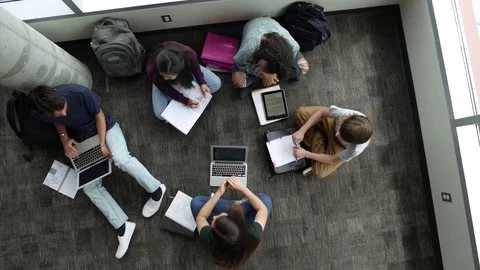 Students talking while studying together on floor 動画素材 83455053