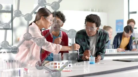 Students testing in lab dipping dropper into blue cup noting result with Stock Footage 333837759