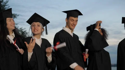 Students throw caps in the air walking. 動画素材 117092455