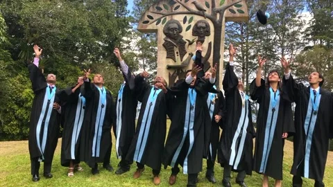Students throwing graduation hats Stock Footage 158456318