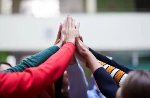 Students together in problem, arm in the air Happy Students Putting their ... Stock Photos