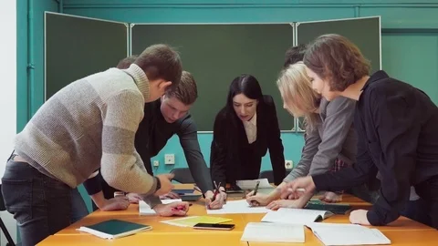 Students together with a teacher working on a startup project at university Stock Footage 86325976