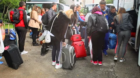 Students traveling on excursion. Young people take luggage from bus Stock Footage 67530008
