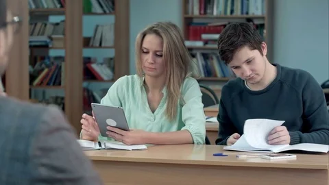 Students typing on tablet computer in a classroom 스톡 동영상 77507870