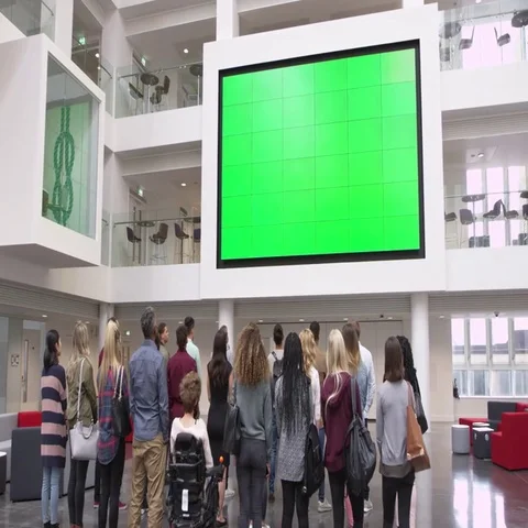 Students under big AV screen in university atrium, back view, shot on R3D Vídeos de archivo 69383881