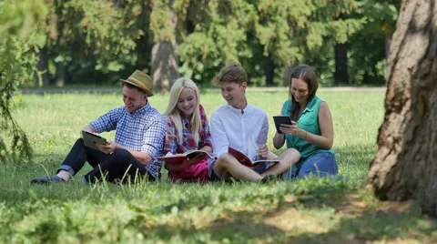 Students Under the Tree Preparing to Exams Outdoors Studying Reading Students Stock Footage 64813117