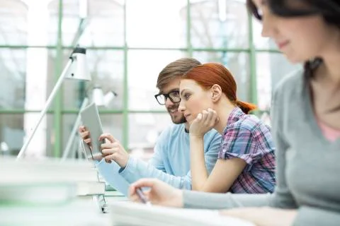 Students in a university library using digital tablet Stock Photos