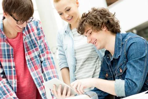 Students in a university library using digital tablet Stock Photos