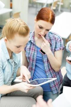 Students in a university library using digital tablet Stock Photos