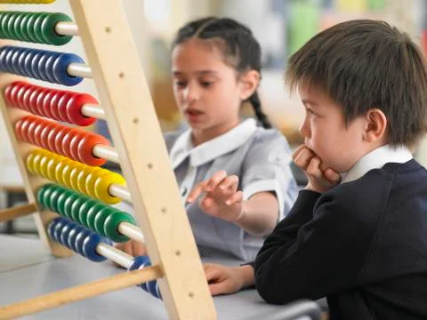 Students Using Abacus In Classroom Stock Photos