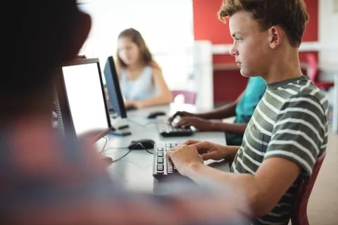Students using computer in classroom Foto stock