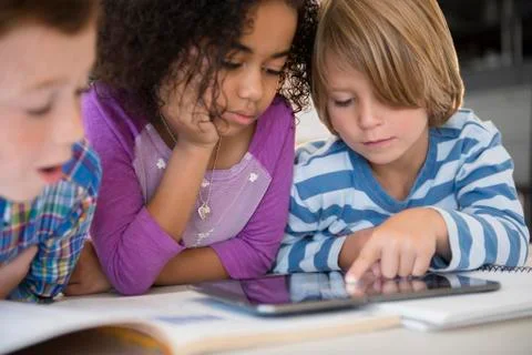 Students using digital tablet in classroom 스톡 사진