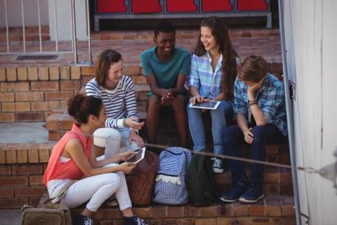 Students using digital tablet on staircase 스톡 사진