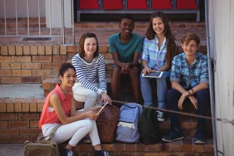 Students using digital tablet on staircase 스톡 사진