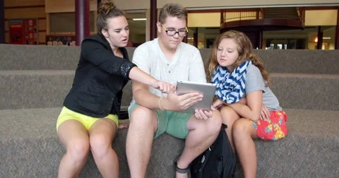 Students using an iPad tablet in a school. Ultra HD 4K Stock Footage 45649832