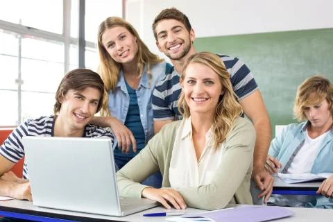 Students using laptop in classroom Foto stock