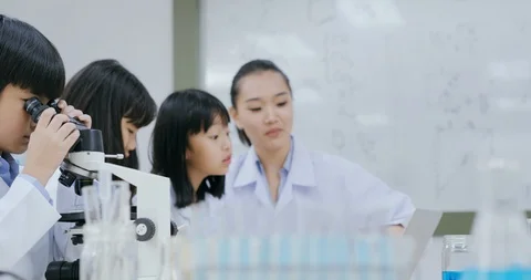 Students using microscope to research with science project. Stock Footage 114719375