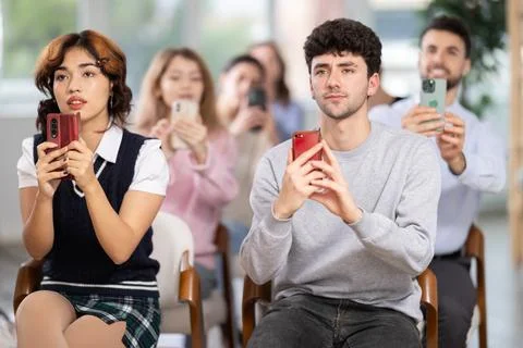 Students using mobile phones to scan QR code during interactive lesson Stock Photos
