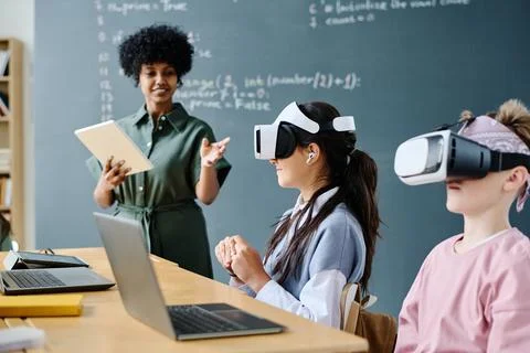 Students using VR glasses at IT lesson 写真素材