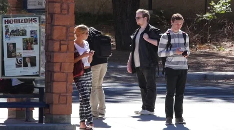 Students wait for a bus on campus Stock Footage 55847785