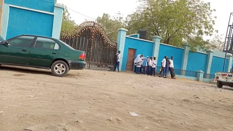 Students Waiting At Closed School Gate By Busy Road Kano Nigeria Видео 330560509