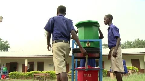 STUDENTS WALK AWAY FROM GREEN AND RED HAND-WASHING STATIONS Stock Footage 60116213