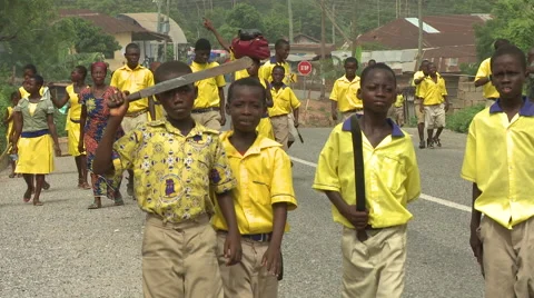 STUDENTS WALK DOWN ROAD CARRYING MACHETES Stock Footage 60633572