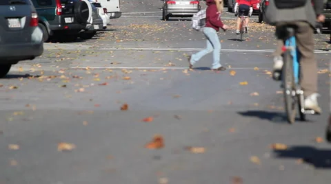 Students walking and biking through campus crosswalk Stock-Footage 5165256