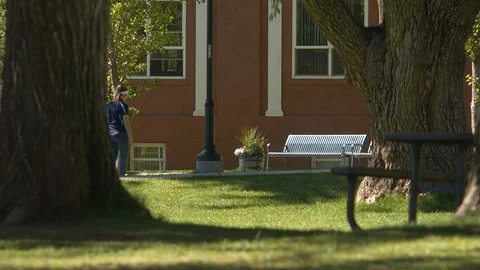 Students walking between classes on a college campus Stock Footage 90722999
