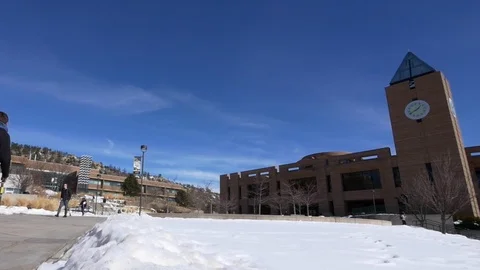 Students walking by clock tower by the El Pomar Center. Stock Footage 100000448