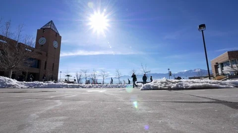 Students walking by clock tower, University of Colorado Colorado Springs. Stock Footage 100001001