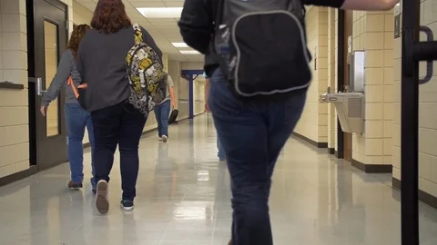 Students Walking Down Hallway with Backpacks Slow Motion Stock Footage 124295982