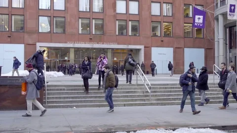 Students walking down steps exiting NYU Stern School of Business front NYC Stock Footage 73342773