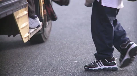 Students walking onto school bus Stock Footage 1077524