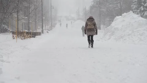 Students walking in snowstorm to class Stock Footage 131181126