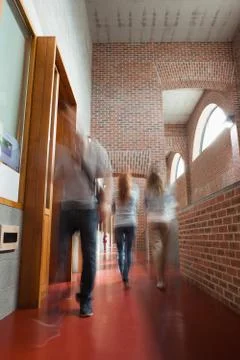 Students walking through hallway away from camera Stock Photos
