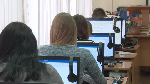 Students work at computers with their backs to the camera. Stock Footage 130442340
