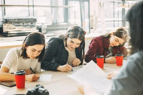 Students work with papers at cafe Stock Photos