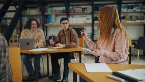 Students work together at a library to complete a project during the afternoon Stock Footage 337111643