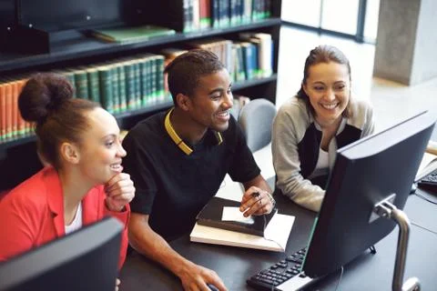 Students working on computer in a college library Foto stock