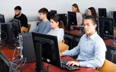 Students working on computers in classroom 写真素材