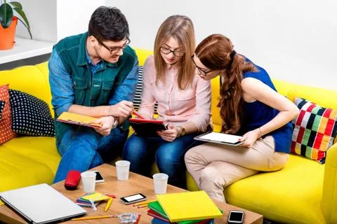 Students working on the couch Stock Photos