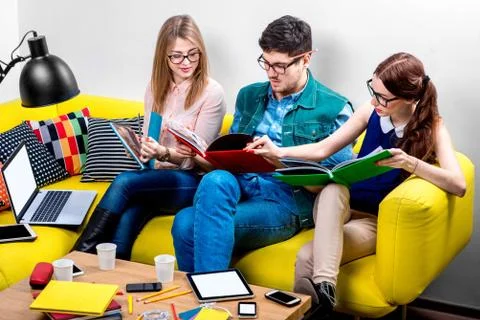 Students working on the couch Stock Photos